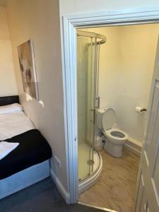 a bathroom with a toilet and a glass shower at Guest House 5 Beds 4 En-suites Middlesbrough in Middlesbrough