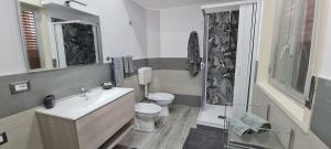 a bathroom with a toilet and a sink and a shower at CASA VACANZE PIAZZA GRAZIA in Caltanissetta