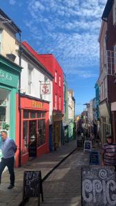 a man running down a city street with buildings at No.2 Folkestone in Folkestone