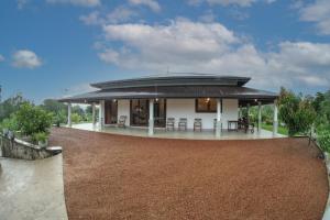 a house with a circular roof with a patio at Plantation Villa in Baddegama