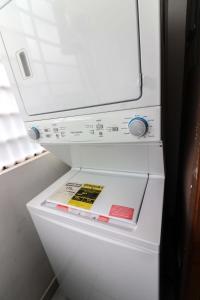 a refrigerator with its door open with a book in it at 3 BR apartment - READY for your stay WIFI Pool Great Location in Santiago de los Caballeros