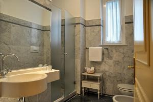 a bathroom with a sink and a toilet at Hotel Cappelli in Montecatini Terme