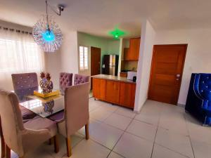 a kitchen and dining room with a table and chairs at 3 BR apartment - READY for your stay WIFI Pool Great Location in Santiago de los Caballeros