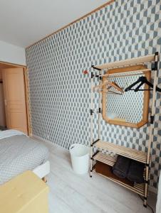 a bedroom with a bed and a mirror on a wall at Maison atypique avec garage 2 roues - Proche Gare in Le Havre