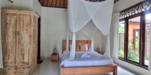 Postel nebo postele na pokoji v ubytování Pandawa Villas Ubud
