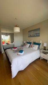 a bedroom with a large white bed with two pillows at Brest and Breakfast vue mer in Brest