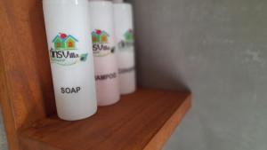 a row of white cups sitting on a shelf at Dins Nature Villa in Elgiriya