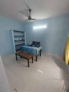 a room with a table and a bench and a ceiling at The Sweet Home in Chennai