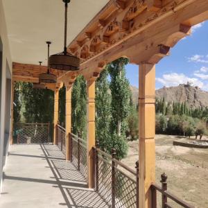 a wooden pergola with a view of the mountains at The Morning Sky hotel in Leh