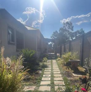 a garden with a pathway leading to a house at Oaktree in Ermelo