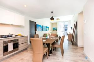a kitchen and dining room with a table and chairs at Beachfront Condo -ROOFTOP POOL OceanView Balcony in Hollywood