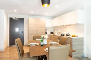 a kitchen and dining room with a table and chairs at Beachfront Condo -ROOFTOP POOL OceanView Balcony in Hollywood