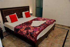 a bedroom with a bed with a laptop on it at Backpackers Karma Home stay in Khajurāho