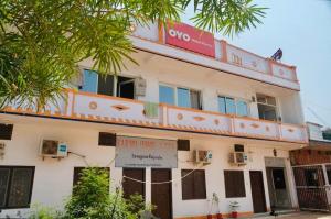 a building with a sign in front of it at Backpackers Karma Home stay in Khajurāho