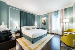 Postel nebo postele na pokoji v ubytování Glimpse Hotel
