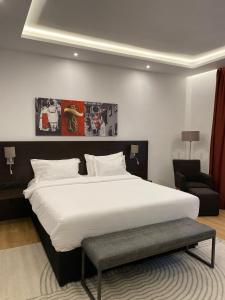 a bedroom with a large white bed and a chair at Republique in Sibiu +132 photos