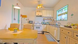 a kitchen with a wooden table and a dining room at beach house Cg7p in Okinawa City
