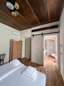 a bedroom with a white bed and a barn door at Stanza in sondrio Coel in Sondrio