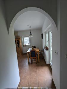 an archway leading to a dining room and kitchen with a table at Forest House in Bled
