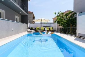 a swimming pool in the middle of a house at Villa Mihaela with private pool, jacuzzi and free secure parking in Trogir