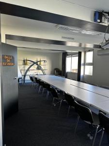 a large conference room with a long table and chairs at L'Aquitaine - Cahors Sud in LʼHospitalet