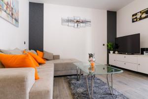 a living room with a couch and a glass table at Villa Mihaela with private pool, jacuzzi and free secure parking in Trogir