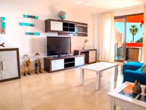 A television and/or entertainment centre at Casares Apartment with swimming pool and sea views
