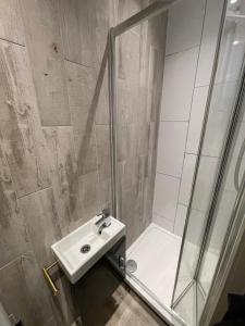 a bathroom with a sink and a shower at Letzi private en-suite Near Wembley in London