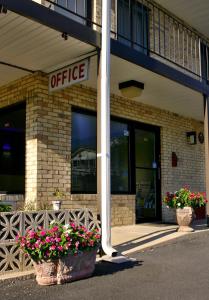 a office building with flowers in front of it at Relax Inn Front Royal in Front Royal