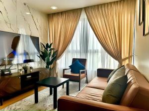 a living room with a couch and a table at 2R2B GAIA RESIDENCE Gamuda Garden Rawang SkylineLuge in Rawang