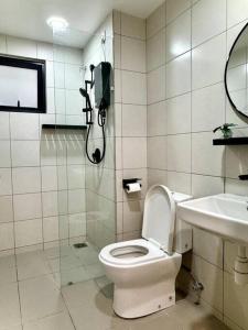 a bathroom with a toilet and a phone on the wall at 2R2B GAIA RESIDENCE Gamuda Garden Rawang SkylineLuge in Rawang