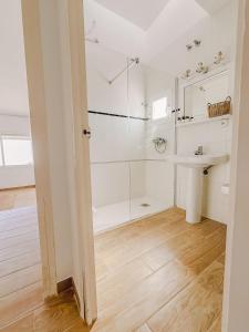 a white bathroom with a sink and a shower at Apartamentos Sol Naixent in L'Ametlla de Mar