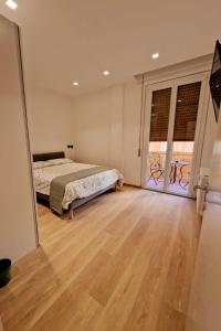 a bedroom with a bed and a large window at Casetta Dante in Ravenna +17 photos