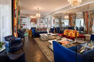 a living room with blue couches and chairs at Harbour Hotel & Spa St Ives in St Ives