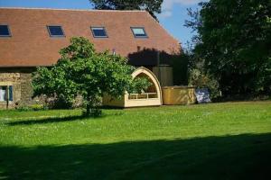 a garden with a gate in the grass in front of a house at La Grange in Sarlande