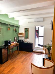 an office with a desk and a computer in a room at Ecorooms Ferrara in Ferrara +25 photos