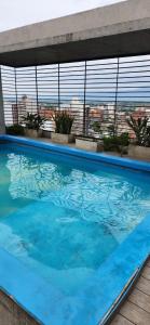 a large blue swimming pool on top of a building at Casita de Tucumán - Loft San Martin in San Miguel de Tucumán