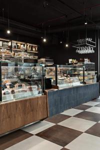 a bakery with a counter with many different types of food at Vistula loft apartment , free parking! in Kraków