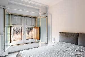 a bedroom with a bed and a window at Euphorbia Apartments by Wonderful Italy in Catania