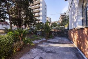 a garden with plants and a building at Euphorbia Apartments by Wonderful Italy in Catania