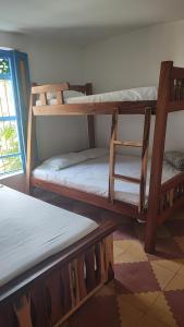 a room with three bunk beds and a window at Hotel sol del lago in Guatapé