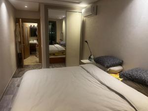 a hotel room with a bed and a mirror at App Alya Casablanca in Casablanca