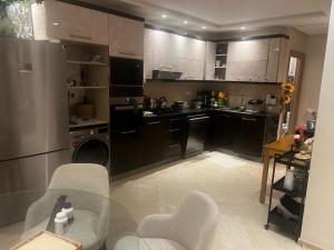 a kitchen with a glass table in a room at App Alya Casablanca in Casablanca