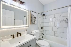 a white bathroom with a sink and a toilet at Tranquil Gainesville Gem with Lanai and Pool Access! in Gainesville +19 photos