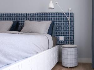 a bedroom with a bed with a blue accent wall at WOW APARTMENT WITH PRIVATE JACUZZI and 2 terraces in Los Cristianos