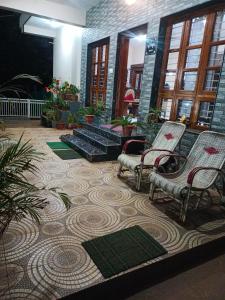 a lobby with two chairs and a rug at Chikmagalur cool stay in Chikmagalūr