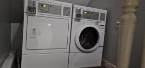 a white washer and dryer in a room at Urban Retreat Studio Apartment in London in London