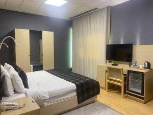 Postel nebo postele na pokoji v ubytování Badam d'Art Boutique Hotel