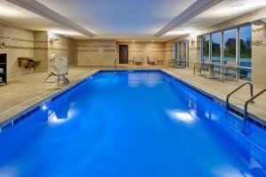 a large swimming pool with blue water at TownePlace Suites by Marriott Grand Rapids Airport Southeast in Grand Rapids
