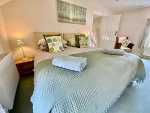 a bedroom with a large white bed with pillows at 5* Family Holiday Home in the Yorkshire Wolds in Huggate
